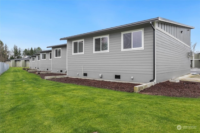 view of side of home with a yard