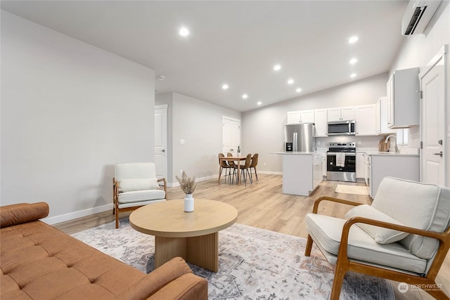 living room featuring a wall mounted AC, vaulted ceiling, and light wood-type flooring