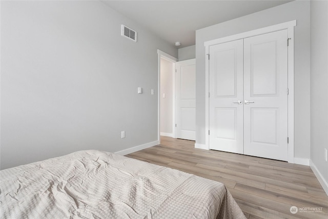 bedroom featuring light hardwood / wood-style floors and a closet