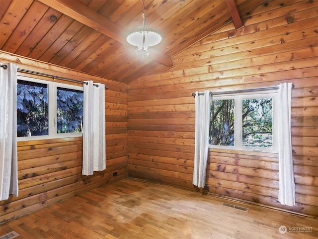 empty room featuring vaulted ceiling with beams, wood ceiling, and light hardwood / wood-style flooring