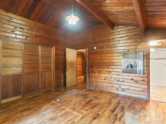 unfurnished bedroom with lofted ceiling with beams, hardwood / wood-style floors, and wood ceiling