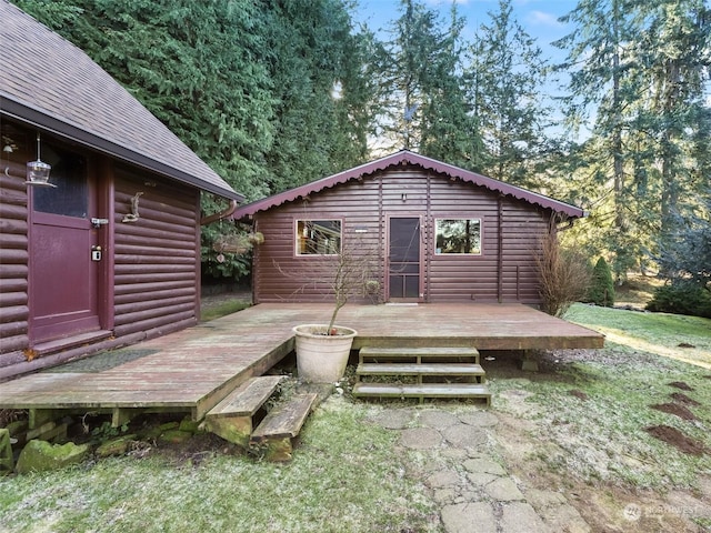 rear view of house featuring a wooden deck