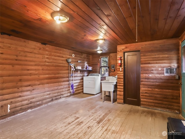 laundry area featuring washer / dryer, wooden ceiling, rustic walls, and light hardwood / wood-style floors