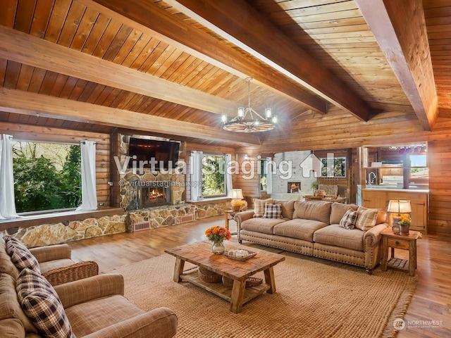 living room featuring a fireplace, wood-type flooring, vaulted ceiling with beams, wood ceiling, and an inviting chandelier