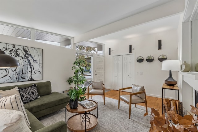 living room with beam ceiling and hardwood / wood-style flooring