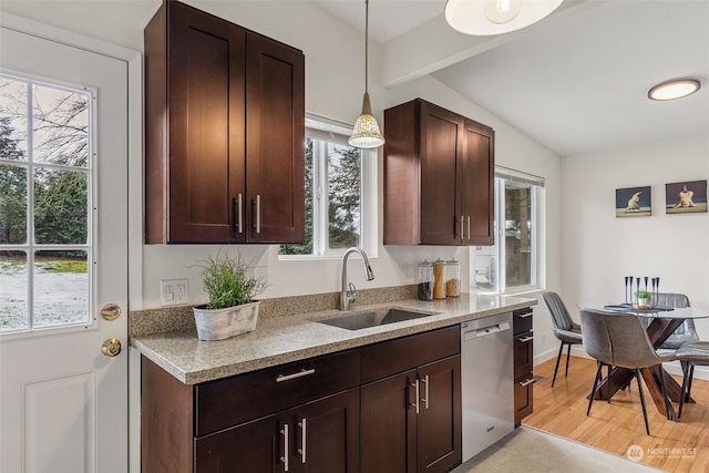 kitchen with sink, vaulted ceiling with beams, decorative light fixtures, dishwasher, and light hardwood / wood-style floors