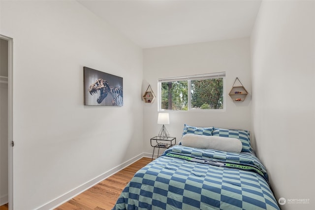 bedroom with hardwood / wood-style floors