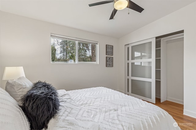 bedroom featuring ceiling fan, lofted ceiling, and light wood-type flooring