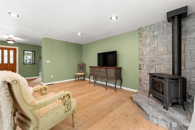 living room featuring hardwood / wood-style floors and a wood stove