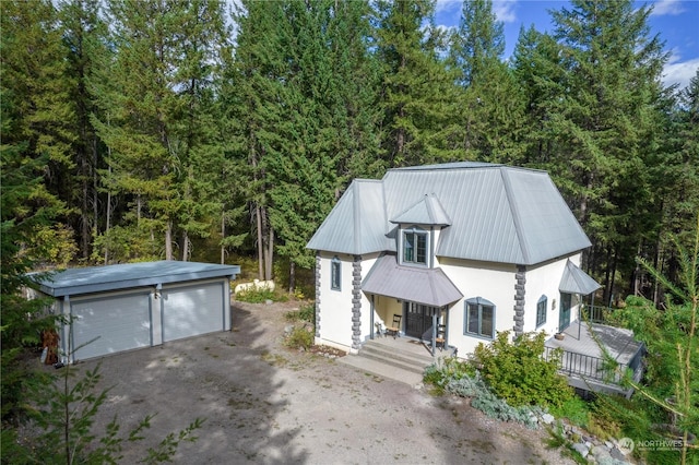 view of front of property featuring an outbuilding, a porch, and a garage