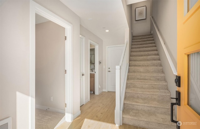 staircase featuring wood-type flooring