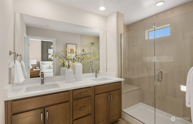 bathroom featuring a shower with door and vanity