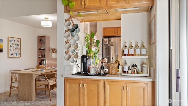 bar featuring stainless steel refrigerator