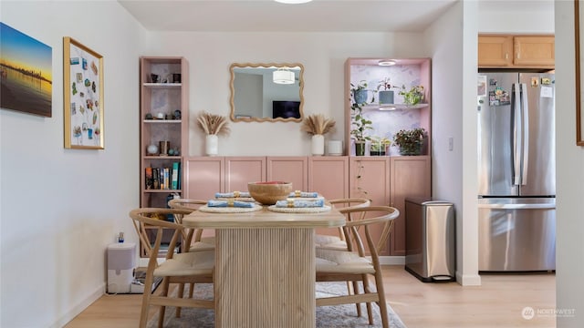 dining space featuring light wood-type flooring