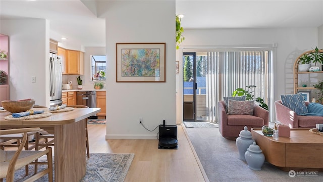 living room with plenty of natural light and light wood-type flooring