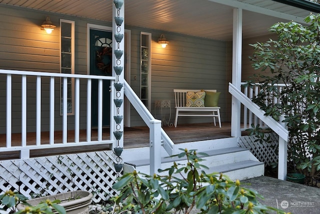 view of exterior entry featuring covered porch