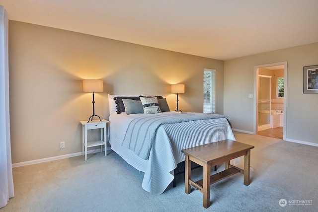 carpeted bedroom featuring ensuite bath