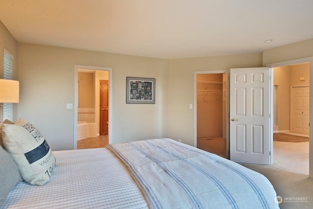 bedroom with light carpet and ensuite bath