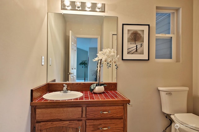 bathroom featuring vanity and toilet