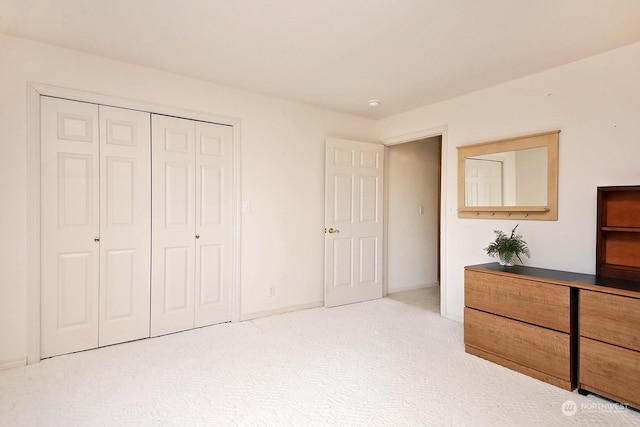 unfurnished bedroom with carpet floors and a closet