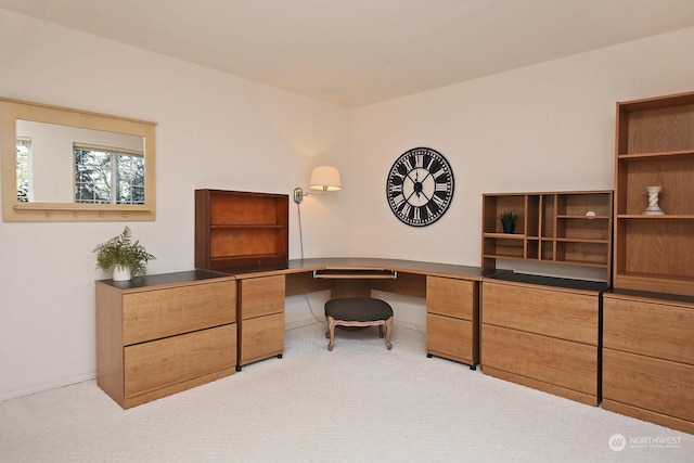 carpeted home office with built in desk