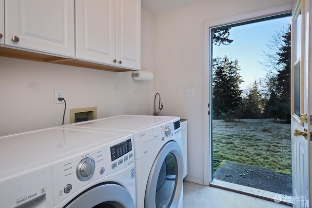 laundry area with independent washer and dryer, cabinets, and a healthy amount of sunlight