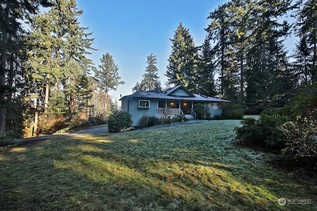 single story home with a porch and a front lawn