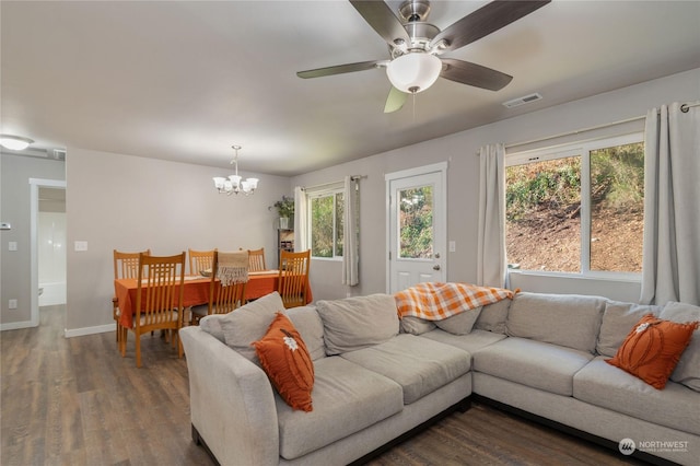 living room with dark wood-type flooring and ceiling fan with notable chandelier