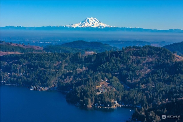 drone / aerial view featuring a water and mountain view