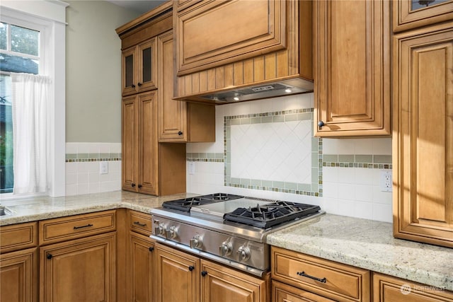 kitchen featuring light stone counters, tasteful backsplash, and stainless steel gas cooktop