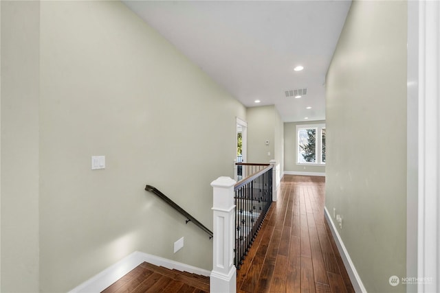 corridor with dark hardwood / wood-style flooring