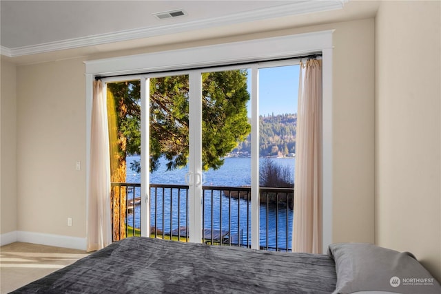 unfurnished bedroom with crown molding, access to outside, and a water view