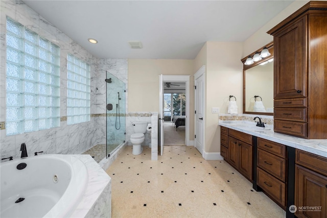 full bathroom featuring vanity, toilet, and separate shower and tub