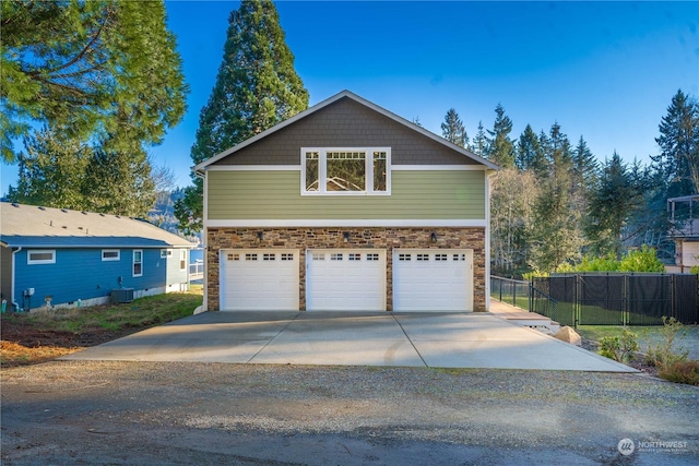 view of home's exterior with a garage and central air condition unit