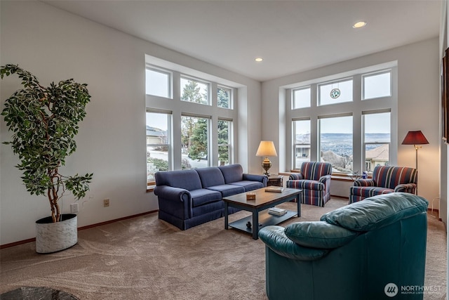 living area featuring recessed lighting, baseboards, light carpet, and a towering ceiling