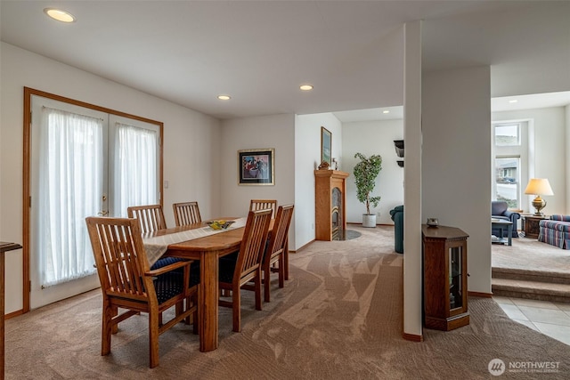 carpeted dining area with recessed lighting and french doors