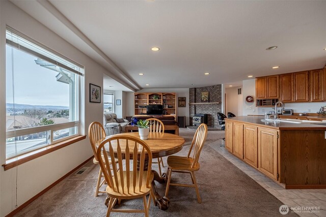 dining room featuring light tile patterned floors, visible vents, baseboards, recessed lighting, and a fireplace