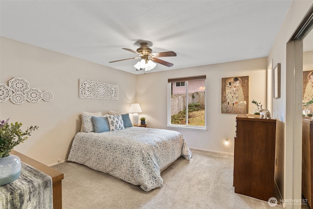 bedroom with light carpet, a ceiling fan, and baseboards