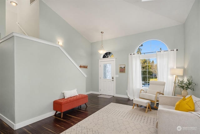 foyer featuring dark hardwood / wood-style flooring and lofted ceiling