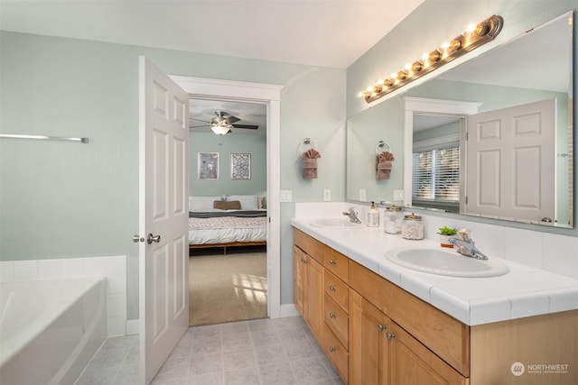 bathroom with vanity, a bathtub, and ceiling fan