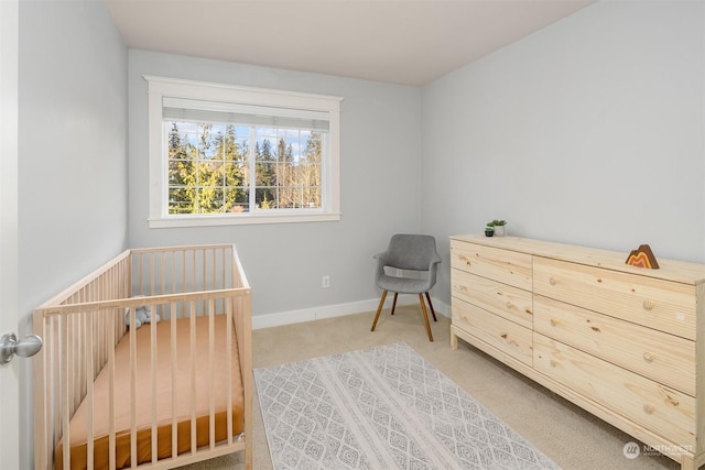 carpeted bedroom with a nursery area