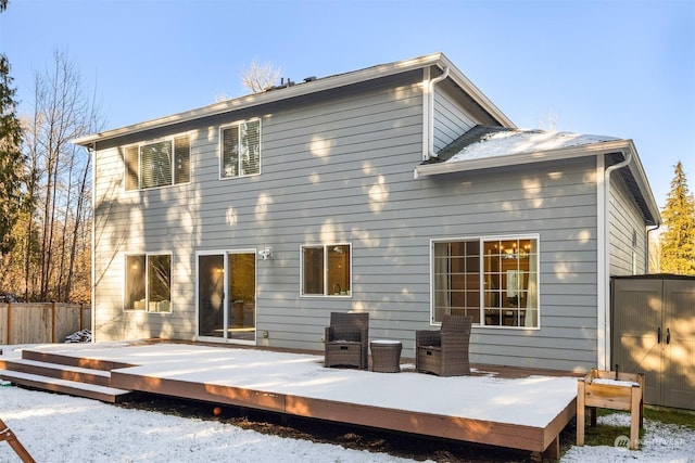 snow covered property featuring a wooden deck