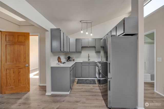 kitchen featuring light hardwood / wood-style flooring, sink, gray cabinets, and appliances with stainless steel finishes