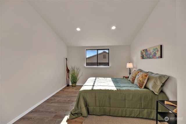 bedroom featuring vaulted ceiling and hardwood / wood-style floors