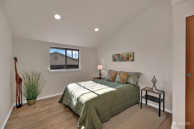 bedroom with hardwood / wood-style flooring and vaulted ceiling