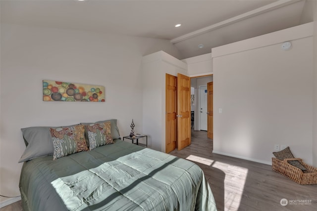 bedroom with vaulted ceiling and wood-type flooring