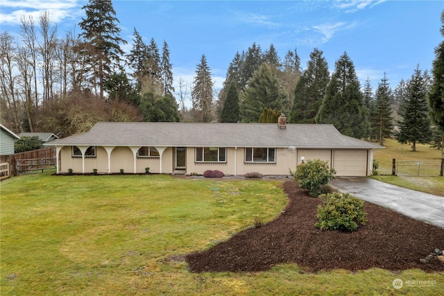 ranch-style house featuring a garage and a front yard