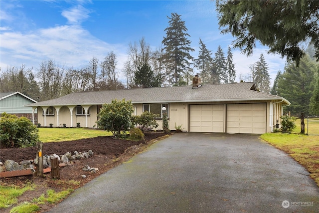 ranch-style home featuring a garage and a front yard