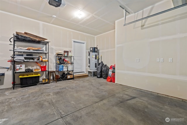 garage featuring a garage door opener and hybrid water heater