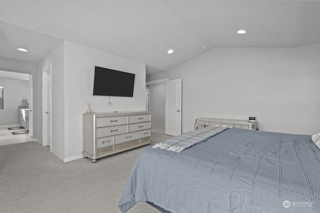 bedroom featuring light colored carpet and lofted ceiling